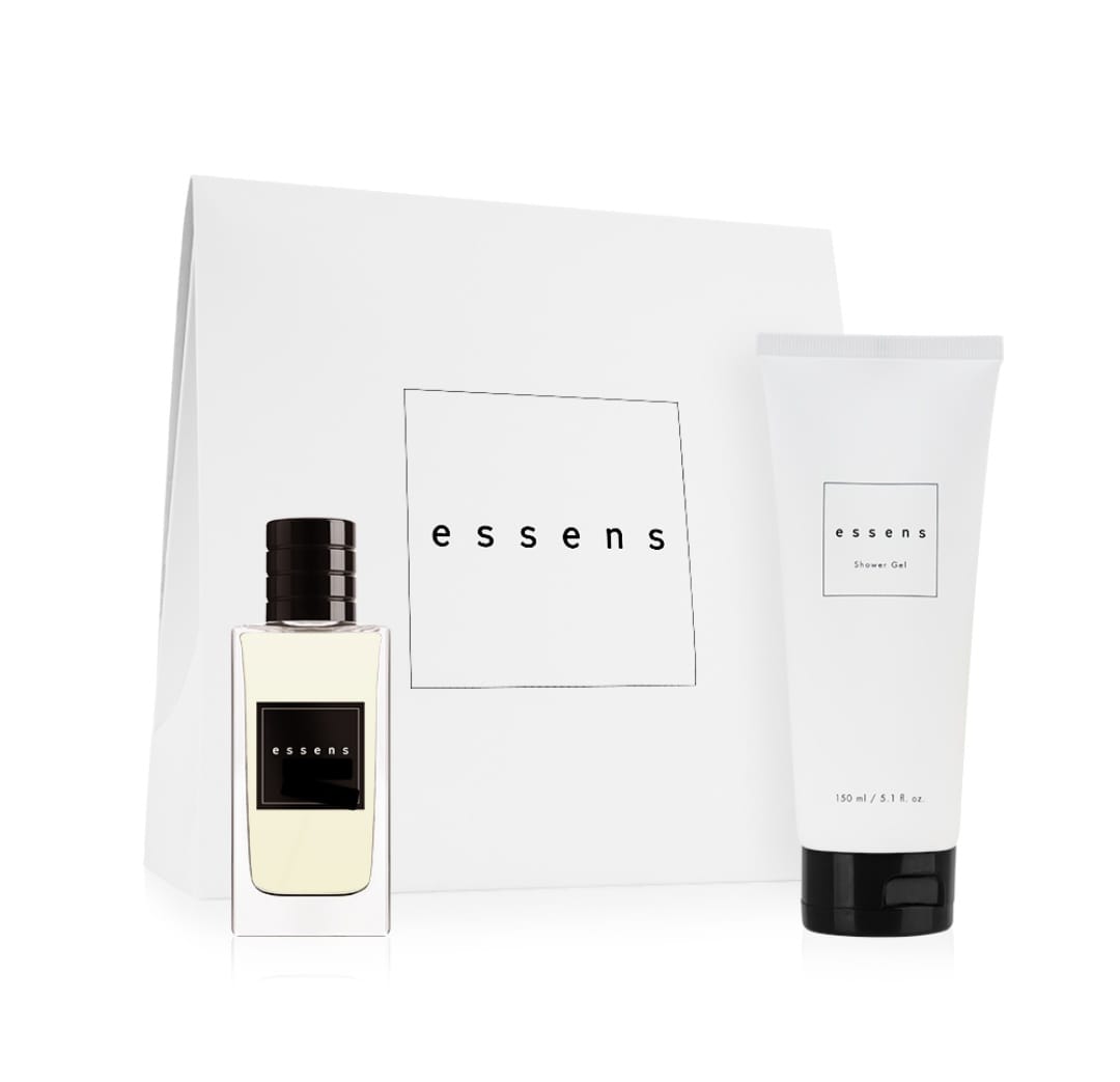 White gift bag with a black-capped perfume bottle and a shower gel