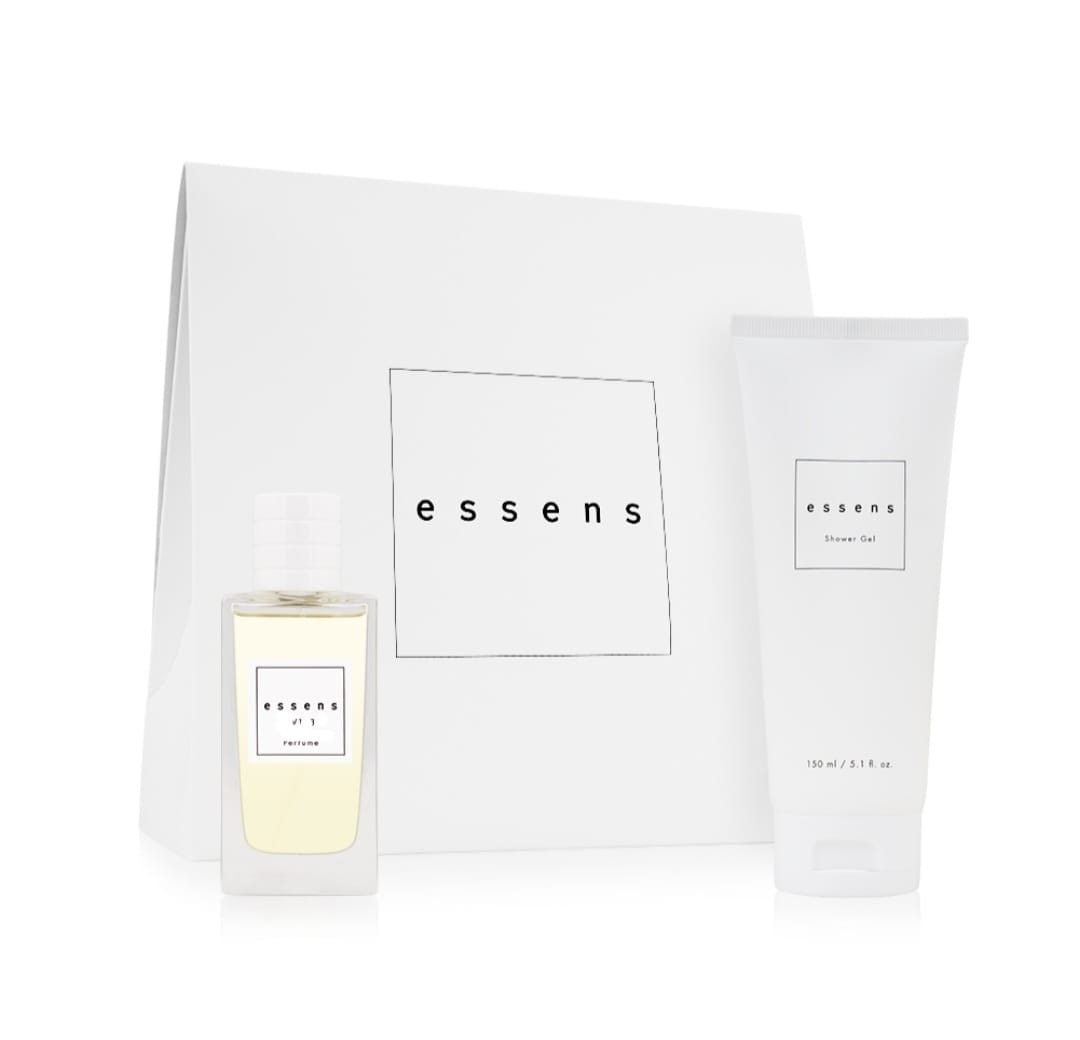 White gift bag with a cream perfume bottle and a shower gel